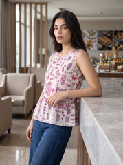 A charming off-white sleeveless top featuring pink, purple, blue, and green paisley motifs for a bright and feminine look.