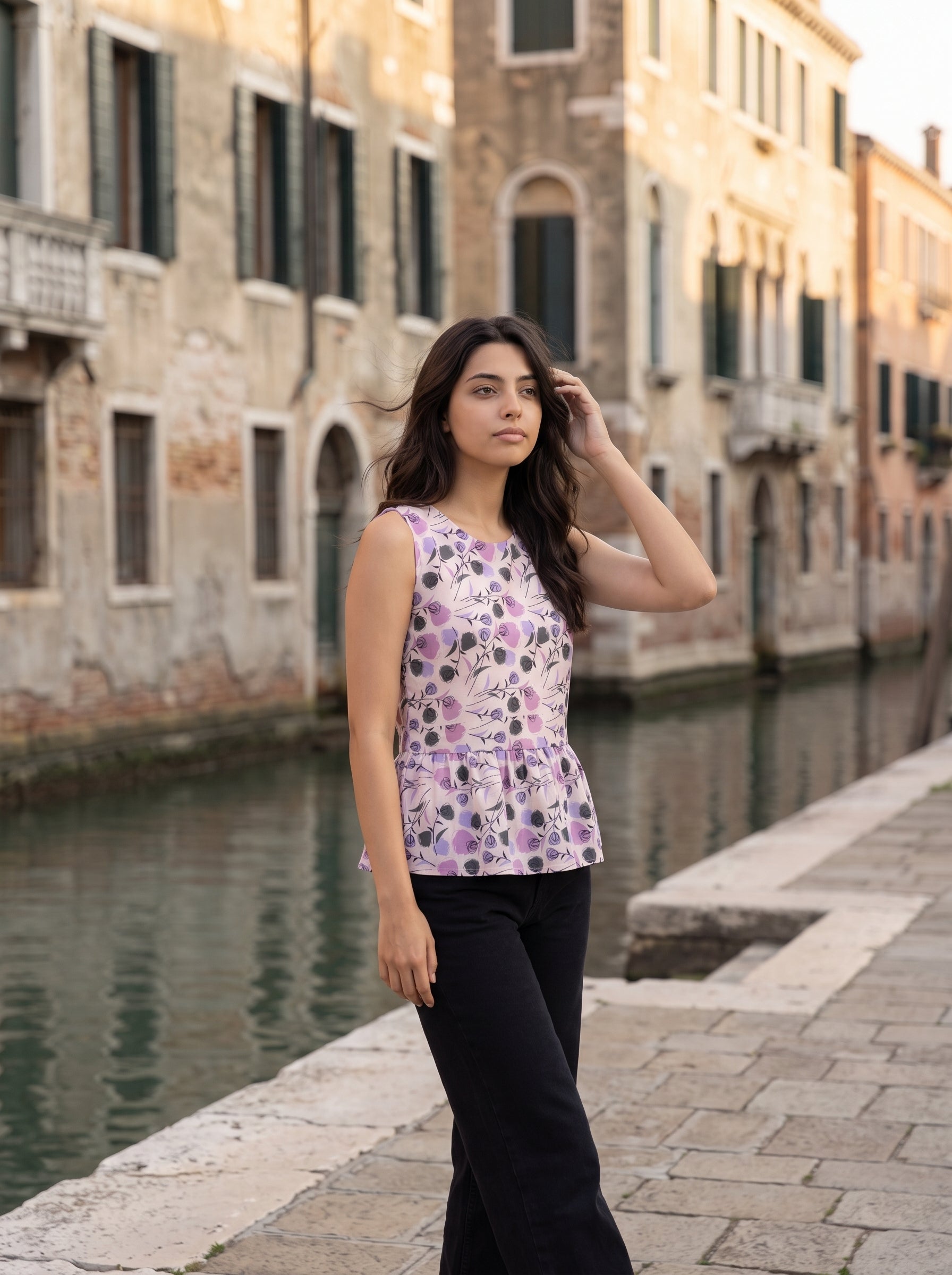 A soft light pink sleeveless top featuring lavender and black rose motifs with artistic botanical accents for a modern feminine look.