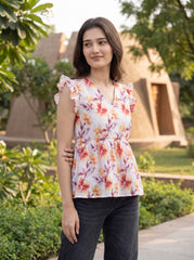 A fresh off-white top featuring rich rust, orange, and burgundy floral motifs for a warm feminine look. 
