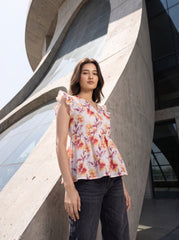 A fresh off-white top featuring rich rust, orange, and burgundy floral motifs for a warm feminine look. 