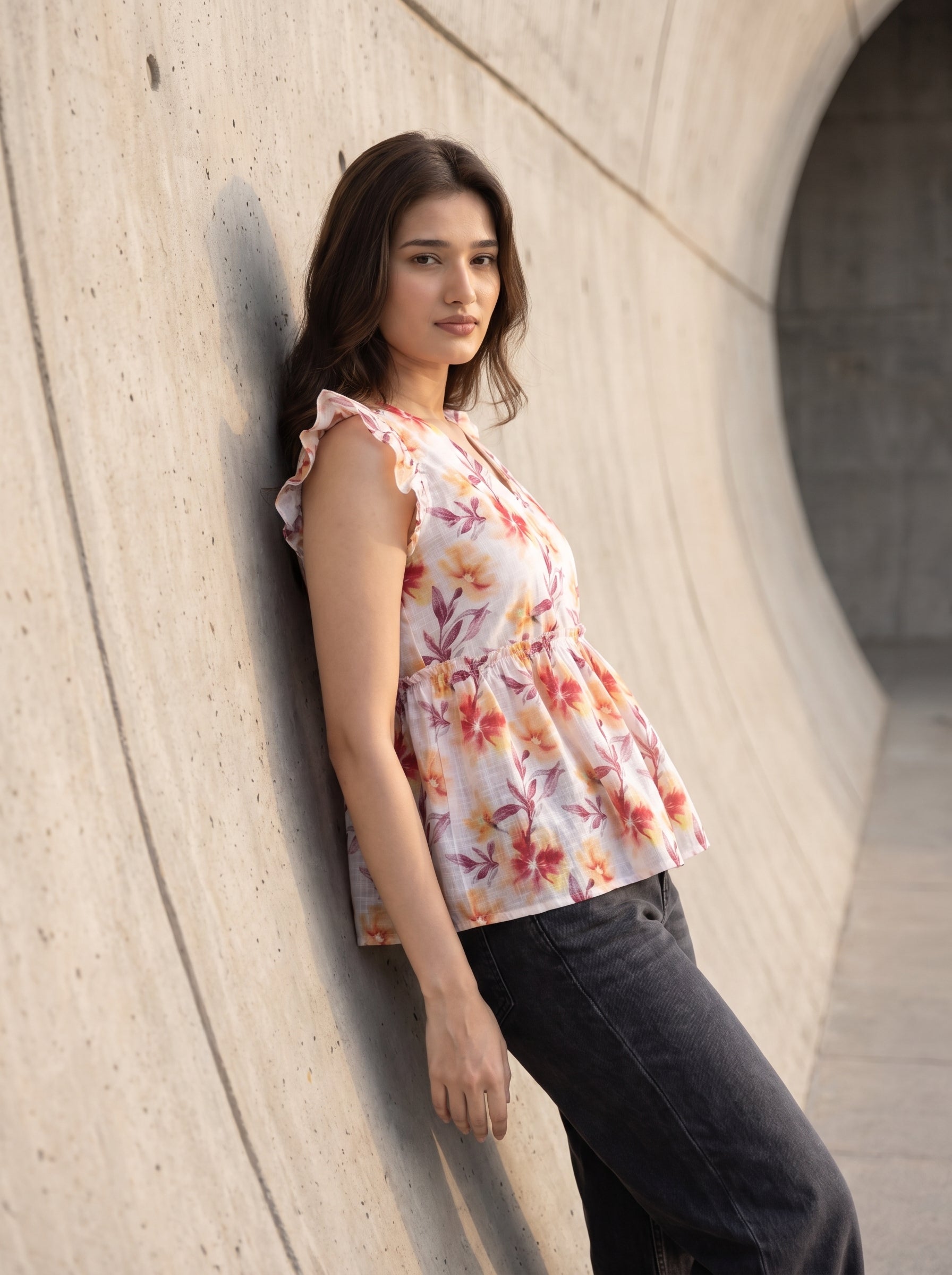 A fresh off-white top featuring rich rust, orange, and burgundy floral motifs for a warm feminine look. 
