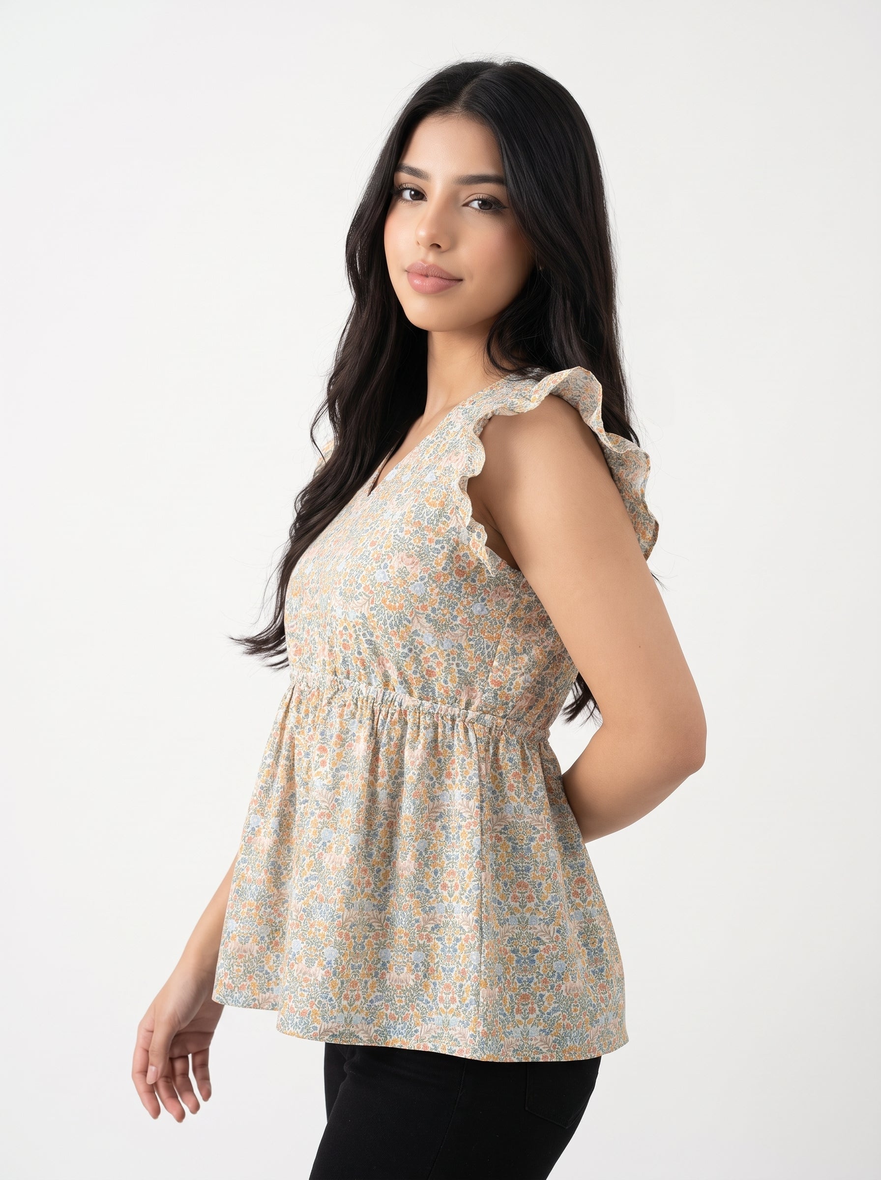 A soft off-white top featuring delicate peach and muted blue floral motifs for a fresh, feminine look.
