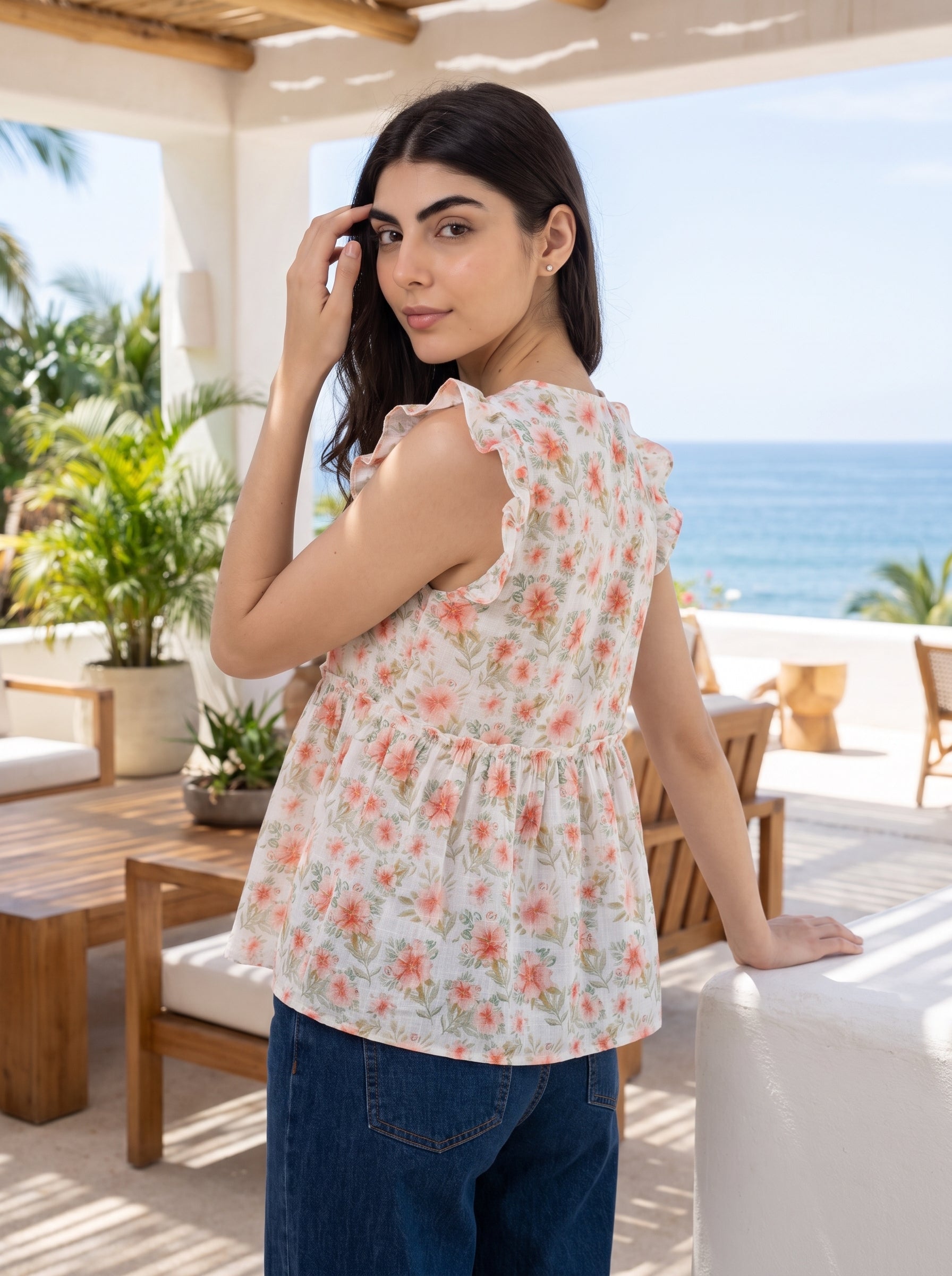 A fresh off-white top featuring soft peach floral motifs with subtle green botanical accents for a feminine everyday look.
