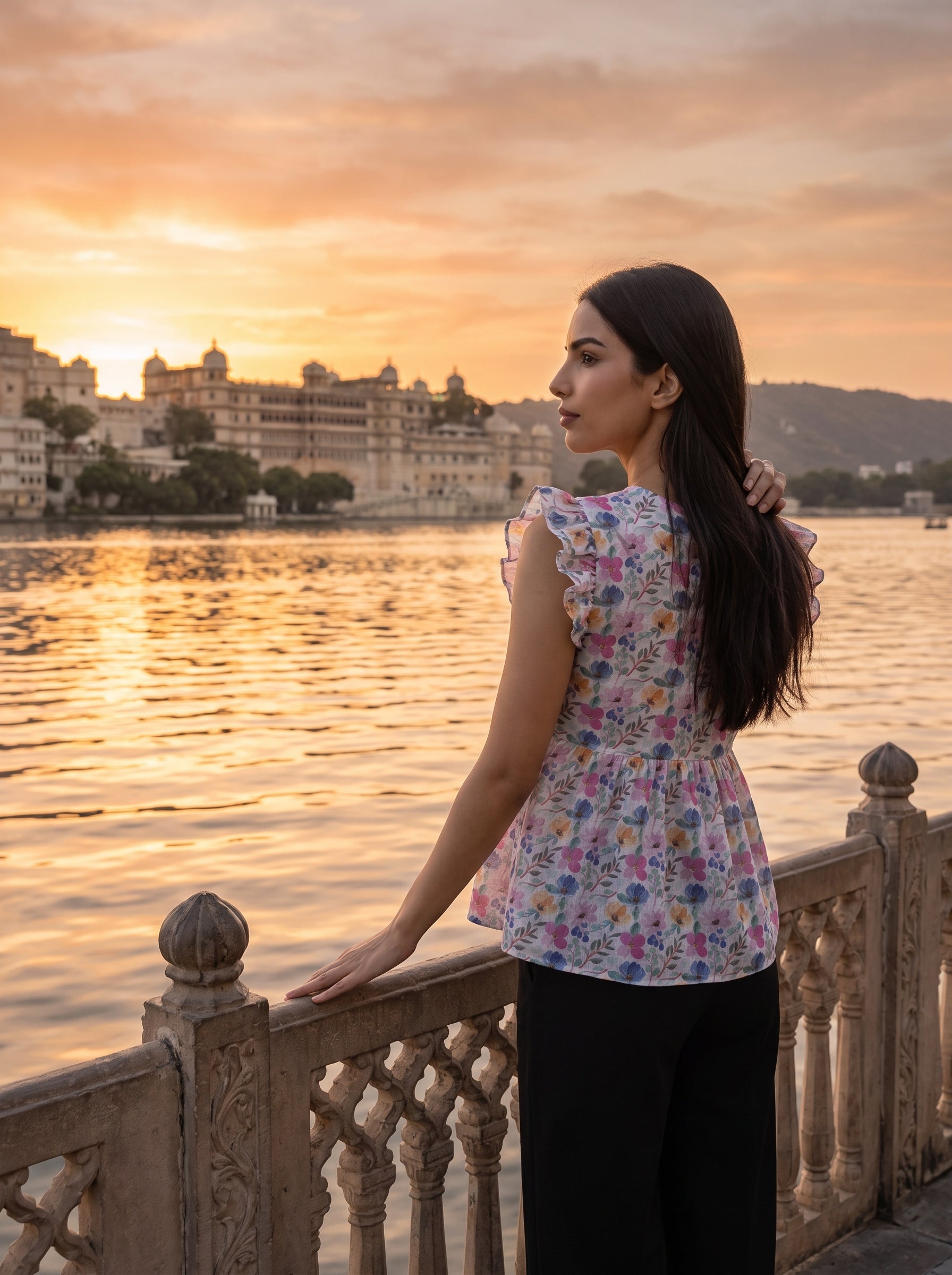A fresh off-white top featuring soft pink, blue, peach, and green floral motifs for a bright feminine look.