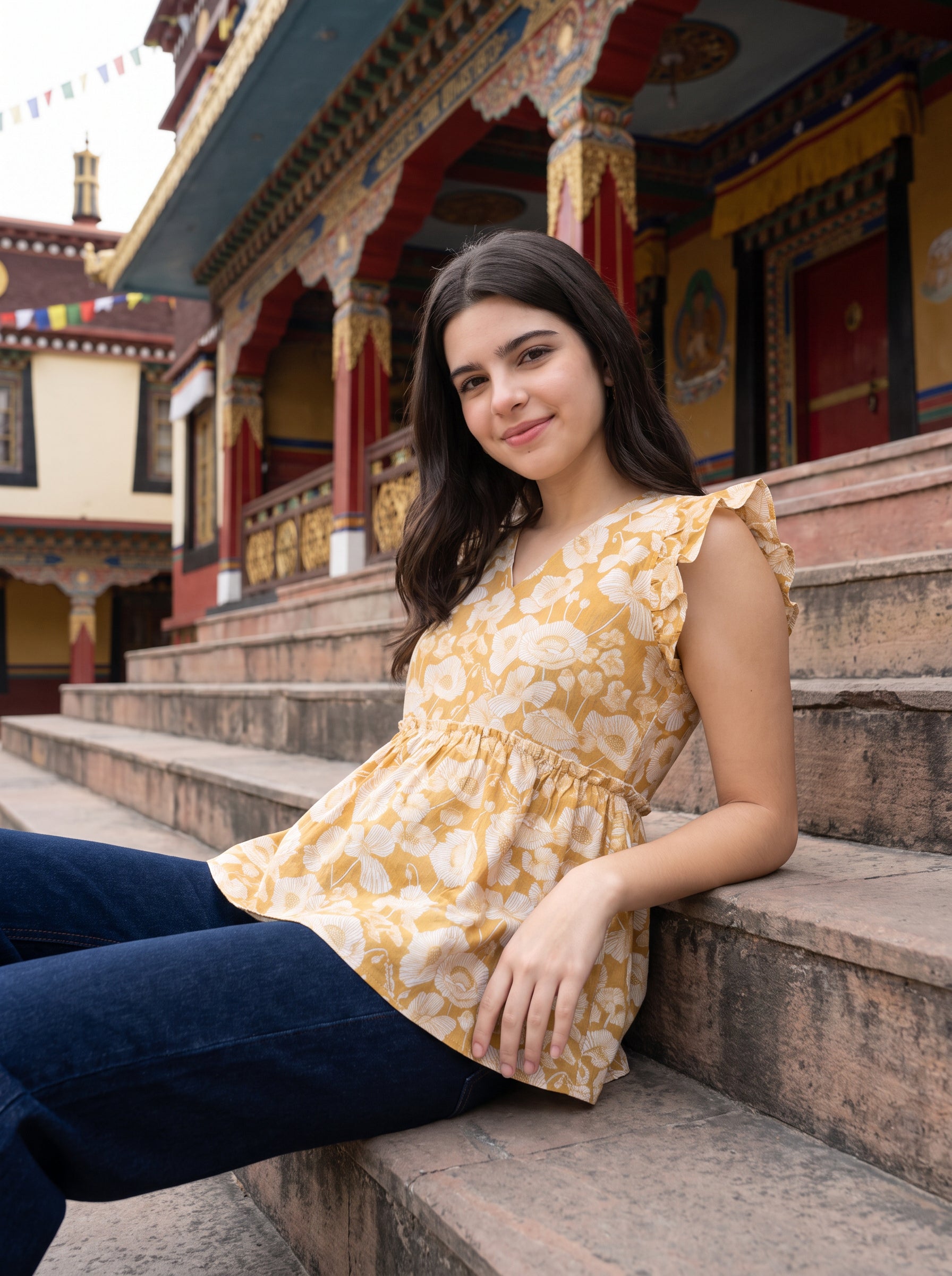 A cheerful mustard yellow top featuring elegant white floral motifs for a bright and feminine look.
