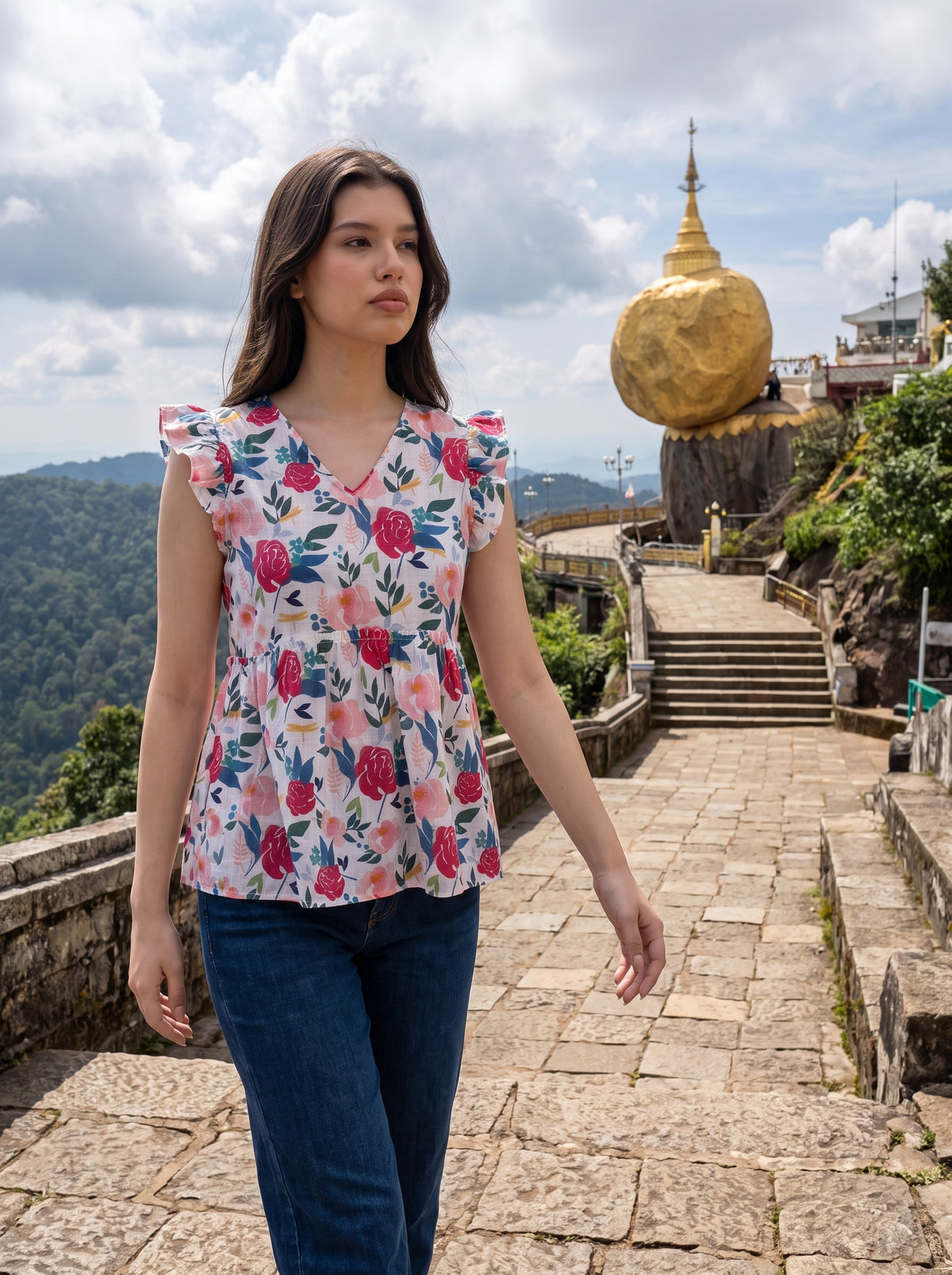 A cheerful floral top featuring bold red and pink roses with blue, green, and mustard botanical accents for a fresh feminine look. 

