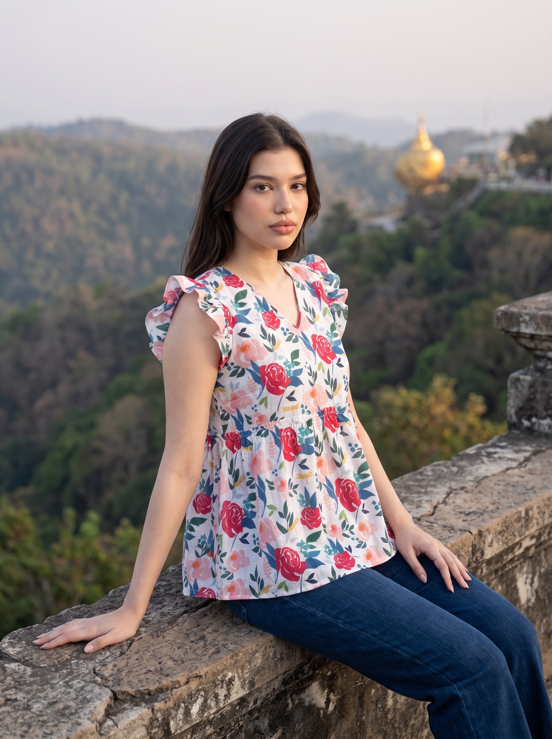 A cheerful floral top featuring bold red and pink roses with blue, green, and mustard botanical accents for a fresh feminine look. 