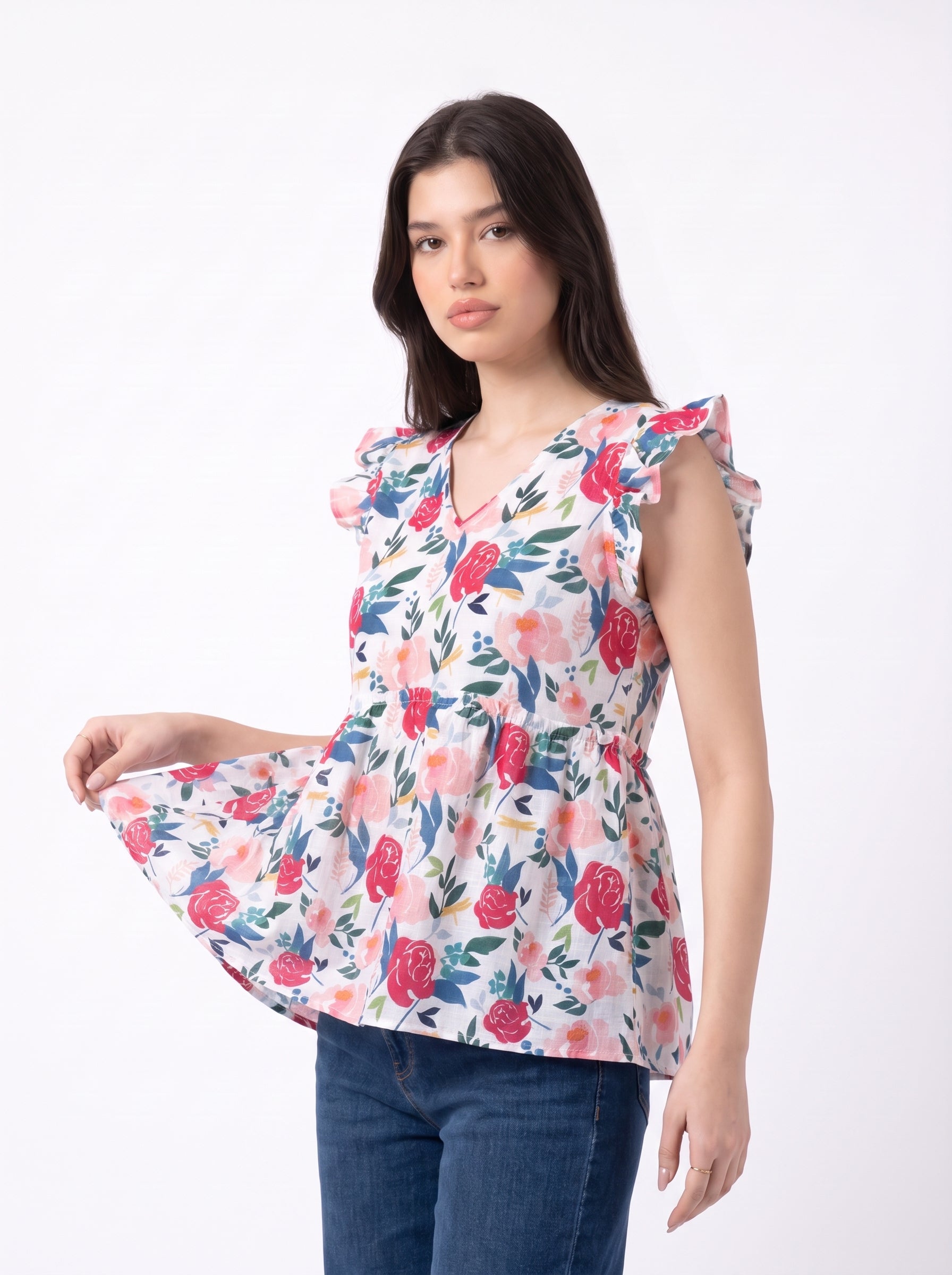 A cheerful floral top featuring bold red and pink roses with blue, green, and mustard botanical accents for a fresh feminine look.
