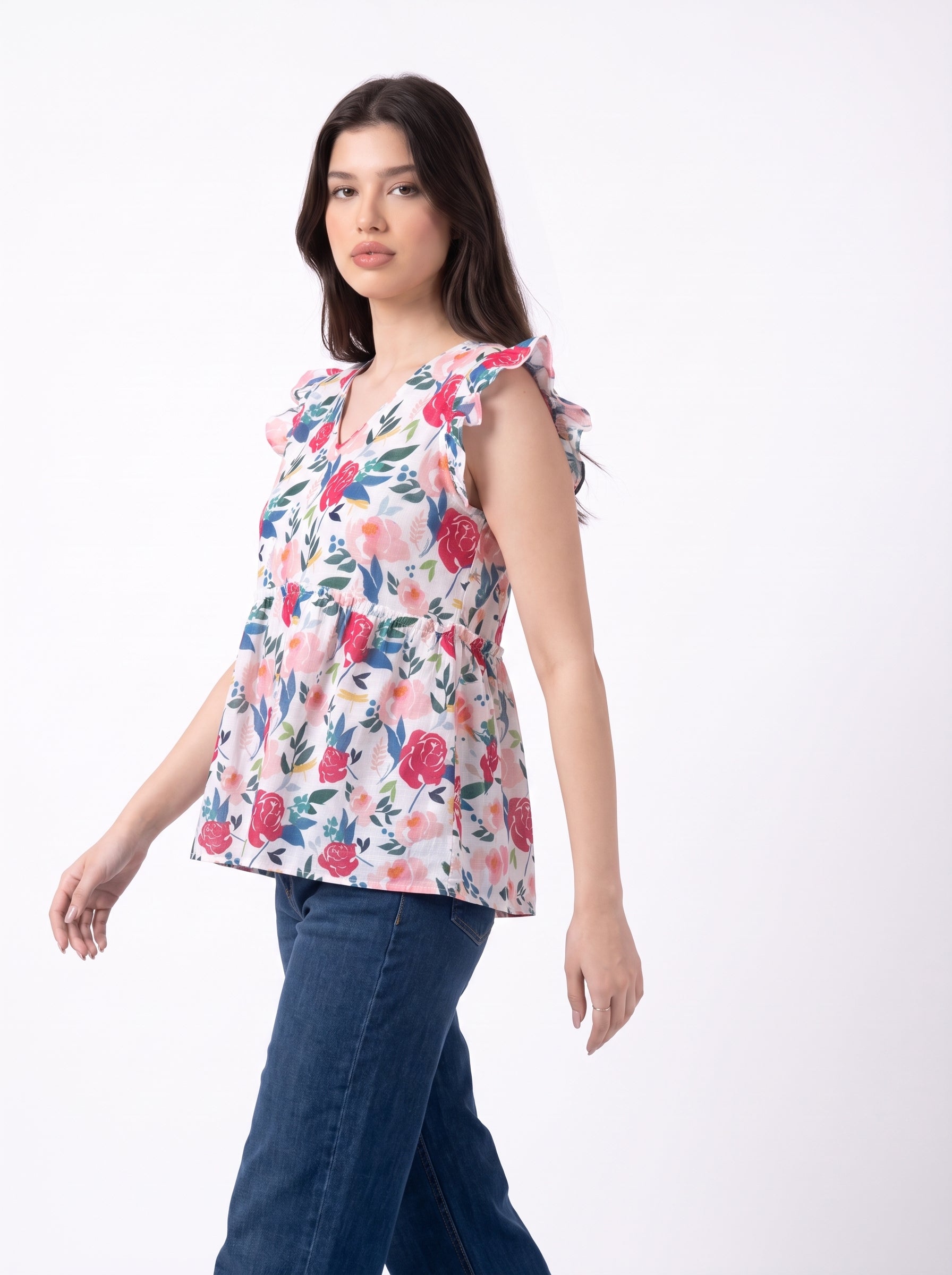 A cheerful floral top featuring bold red and pink roses with blue, green, and mustard botanical accents for a fresh feminine look.