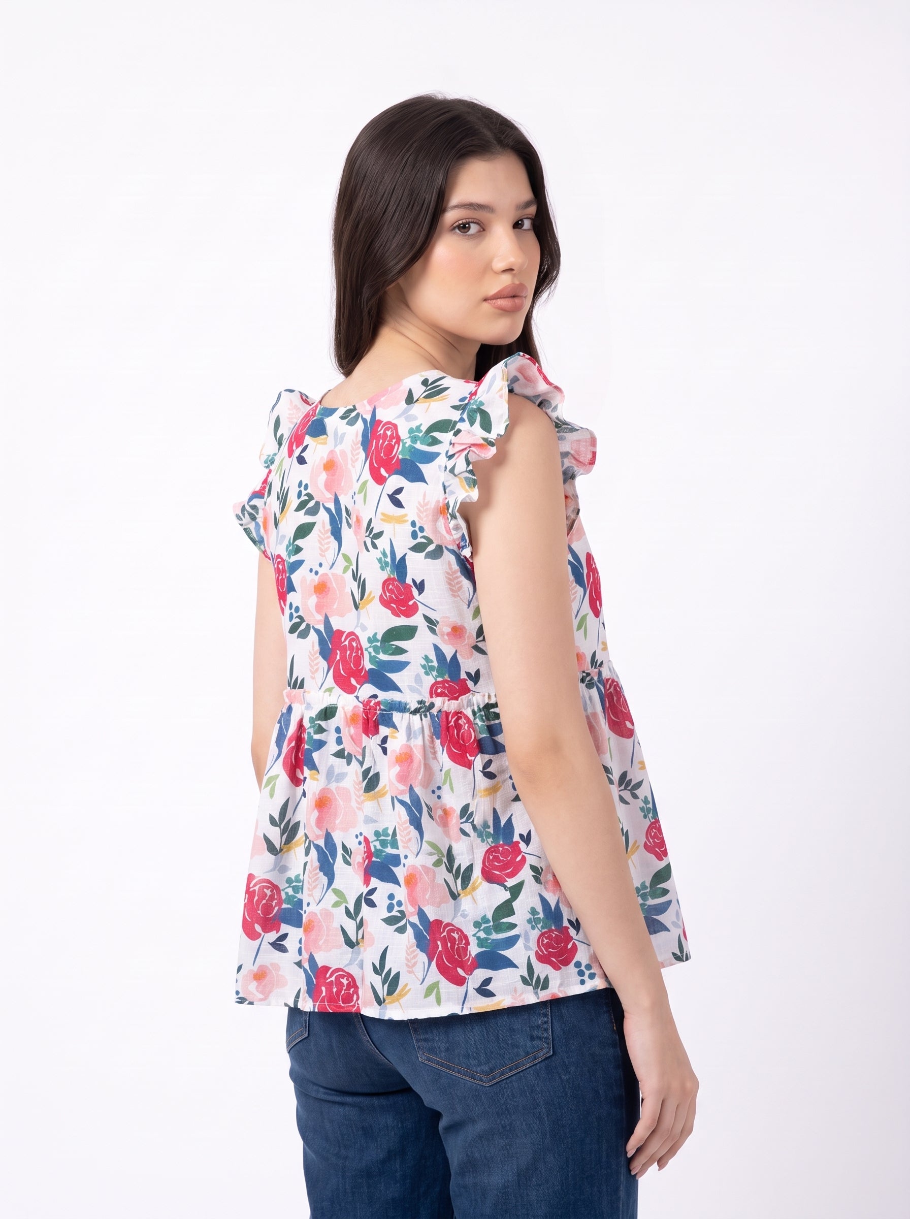 A cheerful floral top featuring bold red and pink roses with blue, green, and mustard botanical accents for a fresh feminine look.