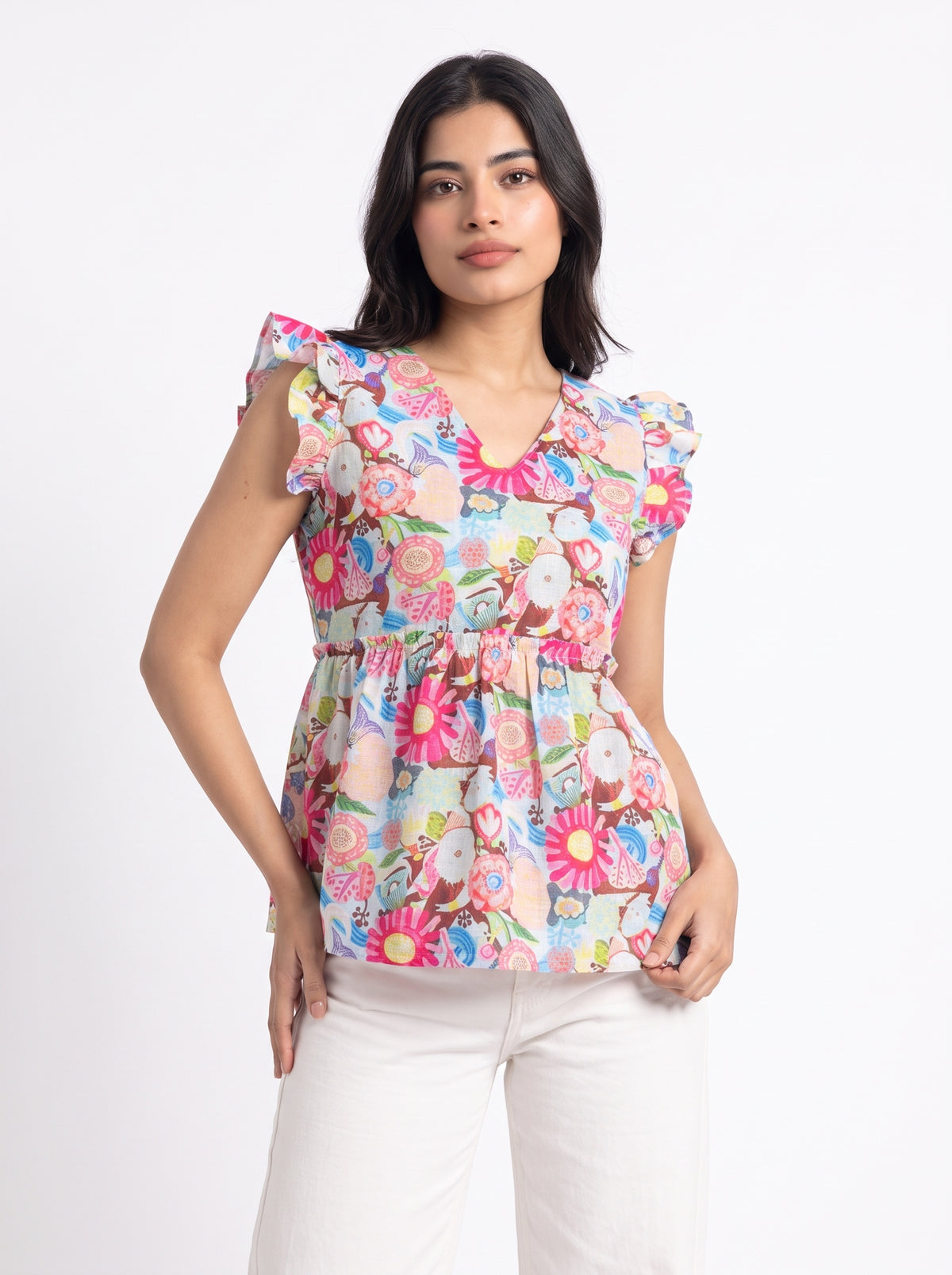 A lively off-white top featuring bright pink, blue, green, peach, and yellow floral motifs for a cheerful statement look. The V-neckline and layered ruffle sleeves add a playful feminine touch, while the gathered peplum waist creates a flattering, flowy silhouette.