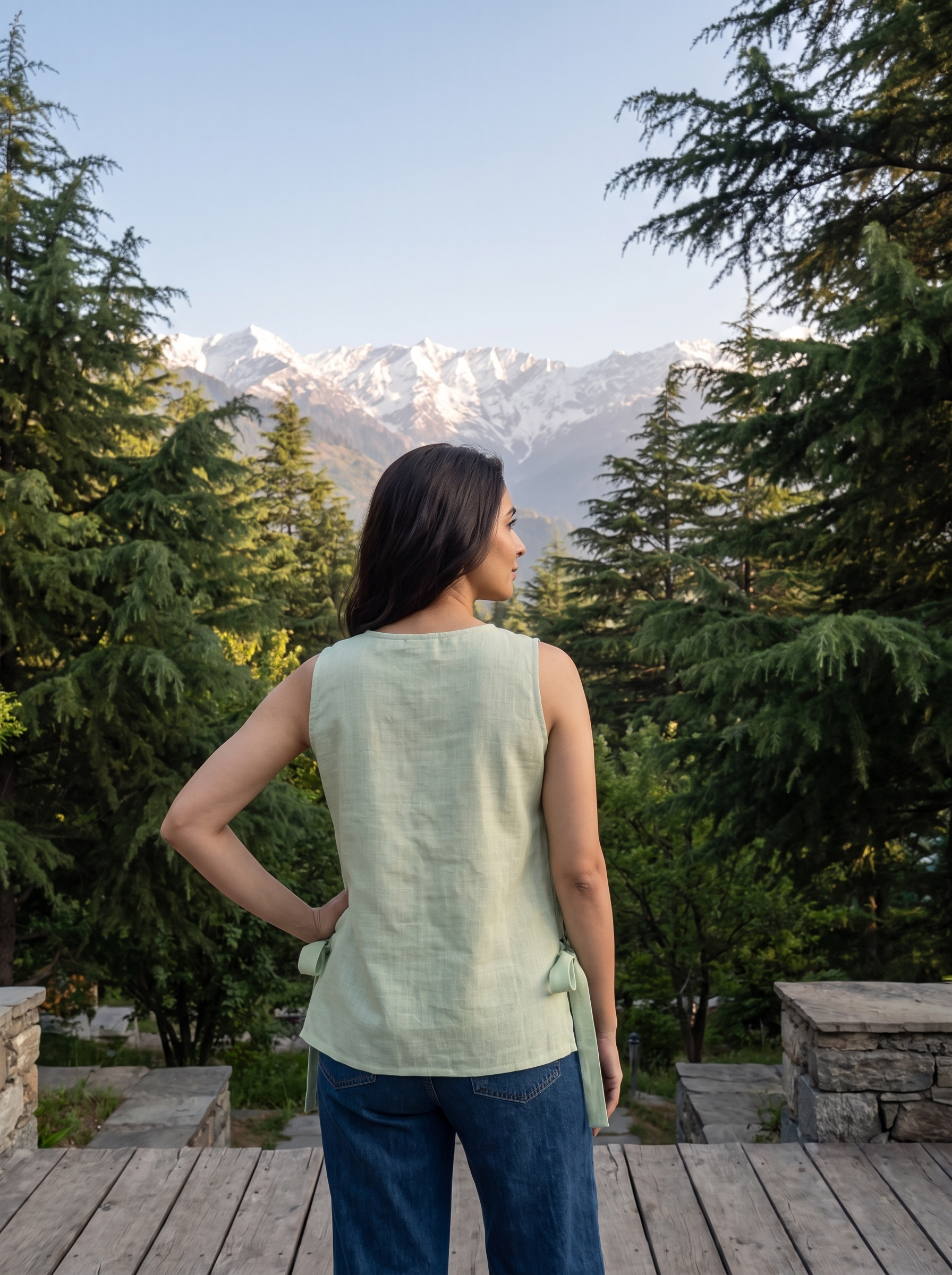 Add a soft feminine touch to your wardrobe with this sage green sleeveless top, featuring delicate multicolor floral embroidery scattered across the front, a clean round neckline, and stylish side tie-up detailing.